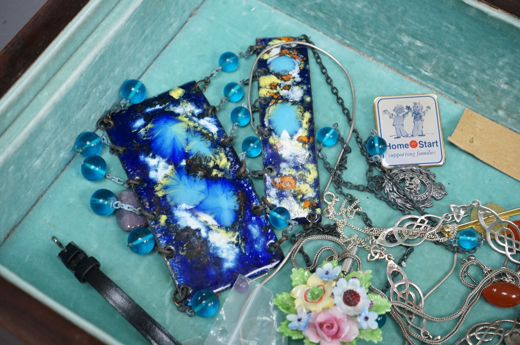 Assorted costume and other jewellery including a cased pair of paste buckles, agate set fob seal, a9ct pendant on a 9ct gold chain, Egyptian white metal bangle, a Scottish silver pendant, etc, housed in a mahogany work b